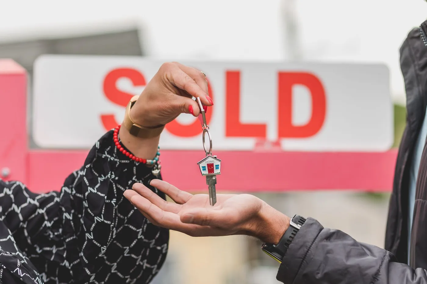 předání klíčů od domu se cedulí SOLD